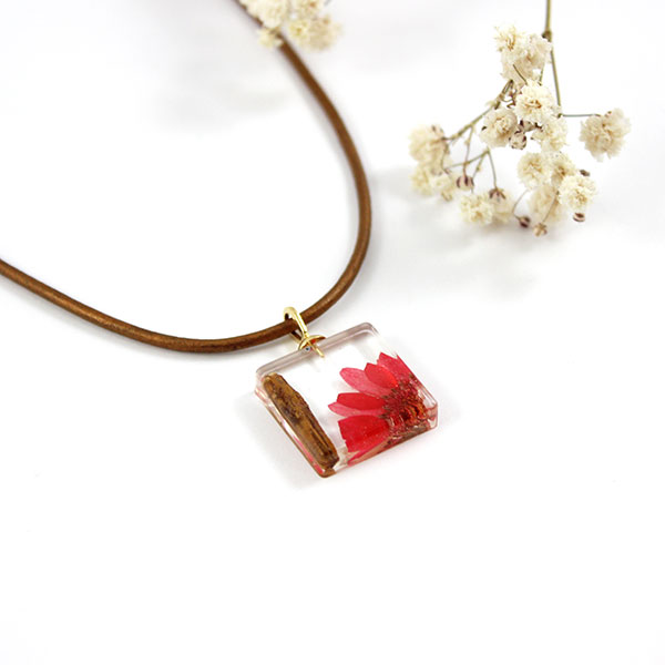 Resin pendant with flower and wood inclusion Resin pendant with flower and wood inclusion