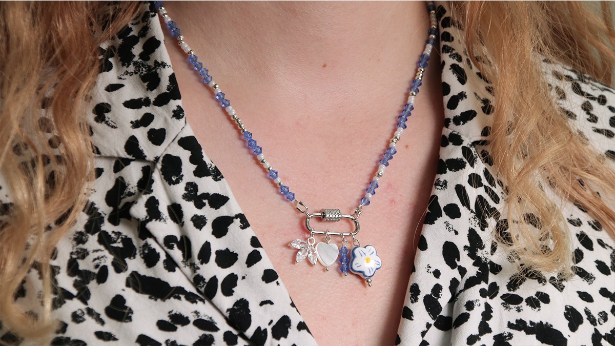 Schema Necklace with lobster clasp, blue spinning tops and accumulation of charms Schema Necklace with lobster clasp, blue spinning tops and accumulation of charms