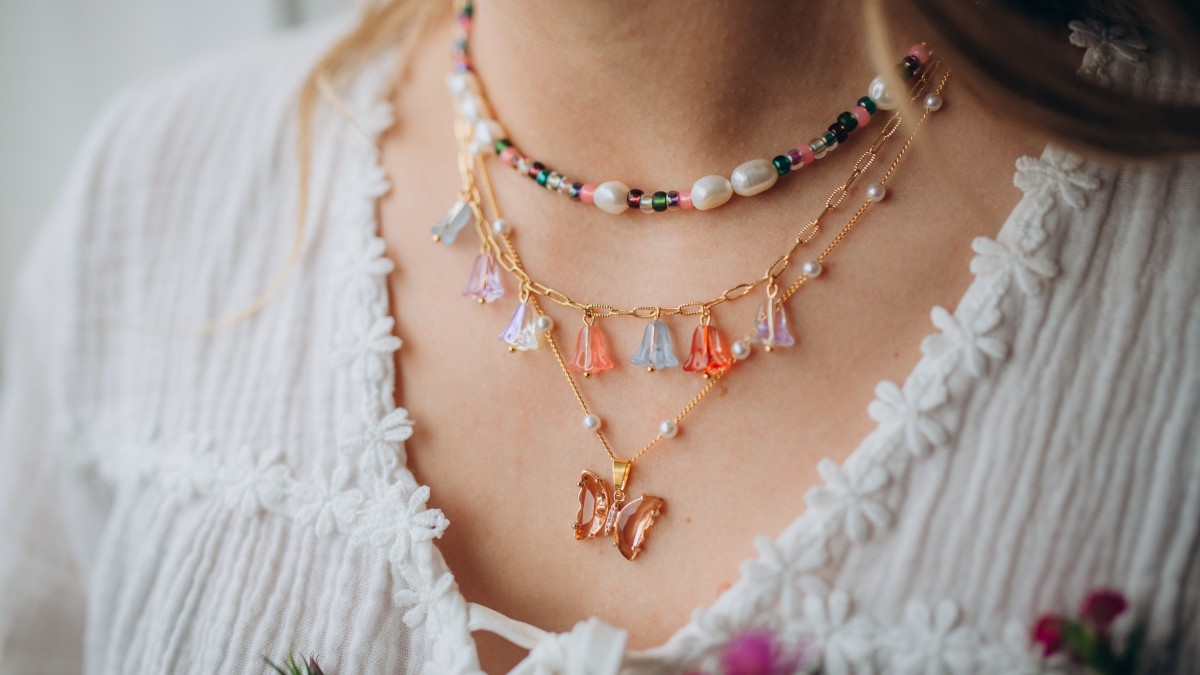 Pink and green necklaces with butterfly pendant and flower beads Pink and green necklaces with butterfly pendant and flower beads